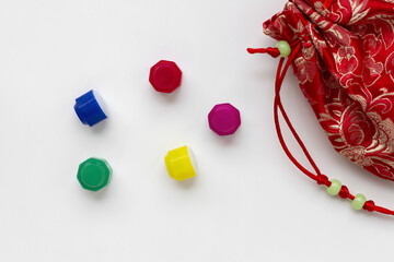 Korean traditional game kit Gonggi. Colourful plastic stones with coloful pouch isolated on white background.