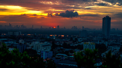 Fototapeta premium The blurred abstract background of the morning sun exposure to the tiny dust particles that surround the tall buildings in the capital, the long-term health issue of pollution.