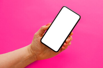Mobile phone with empty white screen in hand on pink background