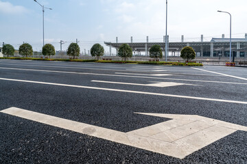 City roads and white indicator arrows on the ground