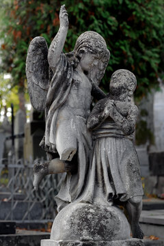 Old tombstone with angel and prayer in Lychakiv cemetery in Lviv Ukraine