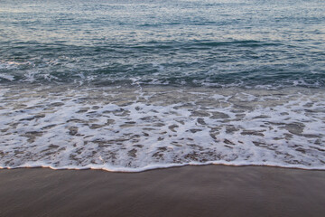 Beautiful seascape with sea waves and sand. Sea waves on the beach.