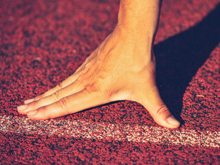 uscular athlete is at the start of the treadmill at the stadium