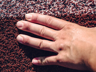 Starting line with outstretched fingers. Stadium racetrack