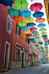 Fototapeta na wymiar Street in Novigrad decorated with umbrellas