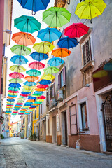 Street in Novigrad decorated with umbrellas