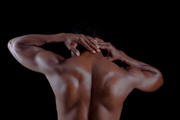 Fototapeta na wymiar Healthy young african man exercising Pain neck. Bodybuilder training on a black background.