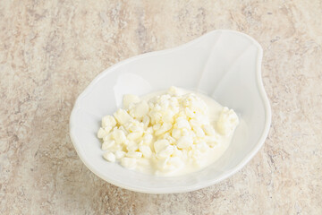 Grained cottage cheese in the bowl