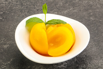Sweet ripe canned peaches with mint