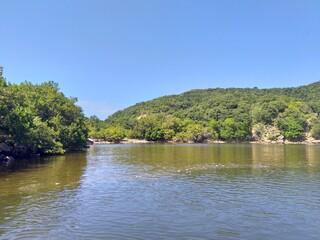 An Indian inspired clay pot partially buried in the mudflat in Orange Valley, Trinidad. In...