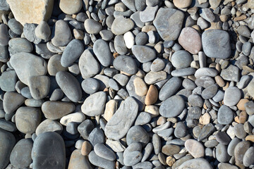 Large photo of pebble stones. Pebble beach, texture, background.