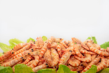 Close up of whole tiger prawns on lettuce leaves with copy space above