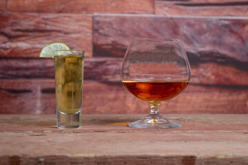 tequila shot and whiskey or brandy cognac in different glasses