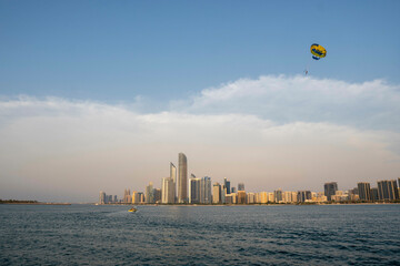 Abu Dhabi, United Arab Emirates skyline with a boating recreation and sunset over the water