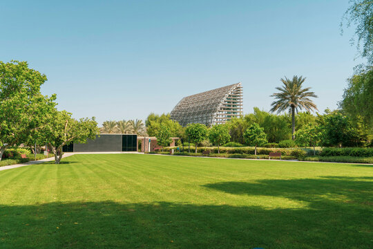 Umm Al Emarat Park in Abu Dhabi Botanical Garden Architectural structure with grass and trees.