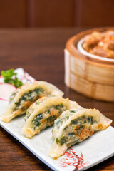 A plate of delicious Chinese fried leek dumplings