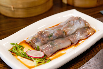 A plate of delicious Cantonese-style morning tea dim sum, steamed beef rice rolls