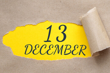 december 13. 13th day of the month, calendar date.Hole in paper with edges torn off. Yellow background is visible through ragged hole.Winter month, day of the year concept