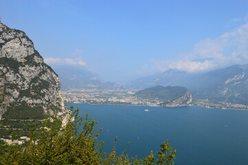 View to Lago di Garda and Riva del Garda mountains and clouds behind 
