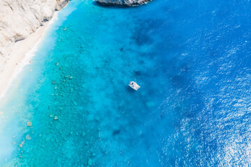 Naklejka premium Aerial shots of famous tourist location of paradise beach in Lefkada, Greece. Luxury yacht boat in Porto Katsiki legendary cliffs and views of breathtaking seascapes