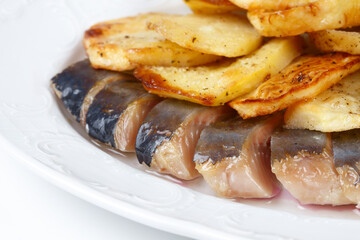 Image of pickled herring with potato and onion