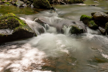 Fototapeta na wymiar Long exposure of the Horner Water river flowing through Horner woods in Somerset