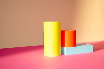 Bright minimalistic abstract background with three-dimensional geometric shapes: cylinders, rectangular podium. podiums for goods. Selective focus, Space for text