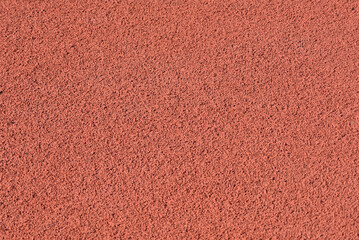 Texture of a rubber crumb for stadium. Rubber asphalt. Resilient coating for sports and athletics fields, jogging, running track and cycling paths - obrazy, fototapety, plakaty