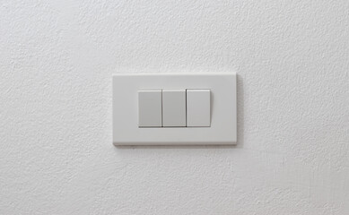 Light onoff switch on white wall with space for text.