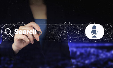 Hand holding digital graphic pen and drawing digital hologram search data sign on city dark blurred...
