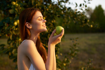 cheerful woman outdoors near apple tree fresh air fruits