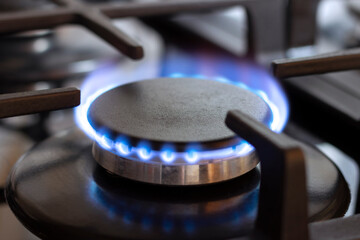 A burning gas burner on the kitchen stove. The use of natural gas for cooking.