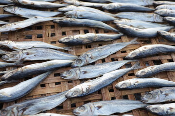 Indonesian salted fish dried on the beach. Food preservation, anchovies are fish that are preserved...