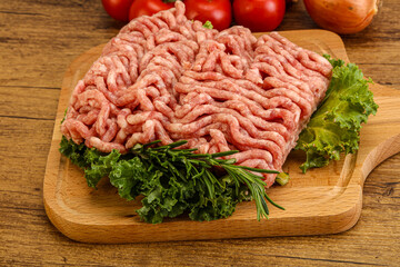 Raw pork minced meat over board