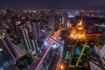 Aerial view of Asoke intersection or junction with cars traffic, Bangkok Downtown. Thailand. Financial district in smart urban city and technology concept.