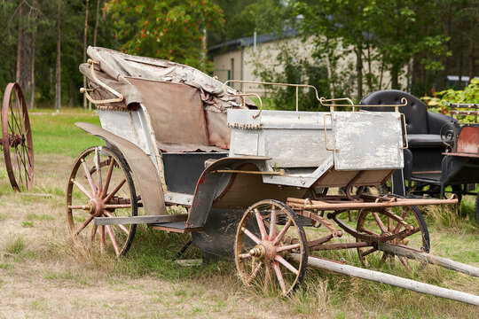 Old carriage in a rural courtyard on a summer day