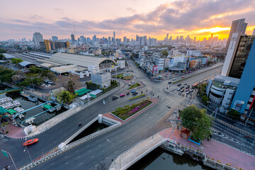 Fototapeta premium Aerial view of Hua Lamphong Railway Station busy street road. Centre intersection or junction in Bangkok Skyline. Thailand. Financial district center in smart urban city. 