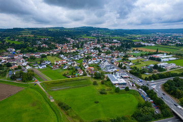 Fototapeta na wymiar Aerial view of the village Hilbringen on a cloudy day in summer 
