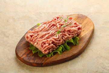Raw minced pork meat over board