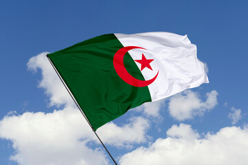 Algeria flag isolated on the blue sky background. close up waving flag of Algeria. flag symbols of Algeria. Concept of Algeria.