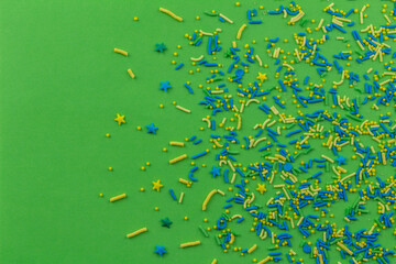 Fototapeta na wymiar Image of sugar sprinkle dots, decoration for cake and bakery, as a green fun background.