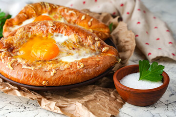 tasty Ajarian khachapuri on grunge background, closeup
