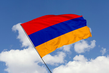 Armenia flag isolated on the blue sky background. close up waving flag of Armenia. flag symbols of Armenia. Concept of Armenia.