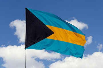 Bahamas flag isolated on the blue sky background. close up waving flag of Bahamas. flag symbols of Bahamas. Concept of Bahamas.