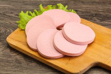 Sliced sausage snak over board