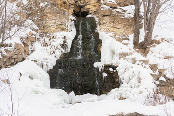 Waterfall in the village Panika, Tver region, Russia. Winter landscape
