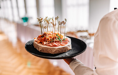 girl the waiter holds tray with food. Restaurant service