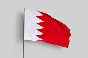 Bahrain flag isolated on the blue sky background. close up waving flag of Bahrain. flag symbols of Bahrain. Concept of Bahrain.