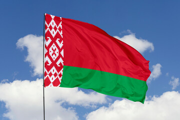 Naklejka na ściany i meble Belarus flag isolated on the blue sky background. close up waving flag of Belarus. flag symbols of Belarus. Concept of Belarus.