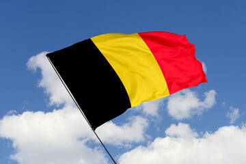 Belgium flag isolated on the blue sky background. close up waving flag of Belgium. flag symbols of Belgium. Concept of Belgium.